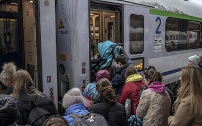 Refugees from Ukraine board a train en route to Warsaw at the railway station in Przemysl, southeastern Poland, near the Polish-Ukrainian border on April 1, 2022. (Angelos Tzortzinis/AFP)