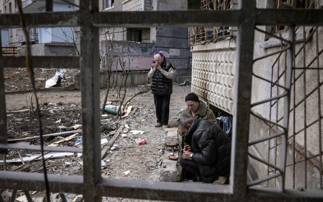 A woman stands in front of a damaged building in the eastern Ukraine city of Kharkiv, on April 2, 2022 (FADEL SENNA / AFP) A woman stands in front of a damaged building in the eastern Ukraine city of Kharkiv, on April 2, 2022 (FADEL SENNA / AFP)