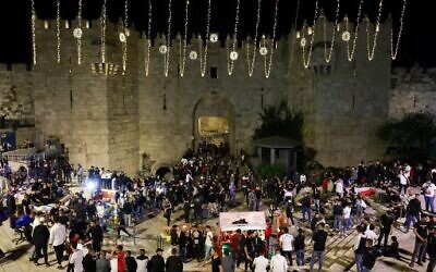 Palestinians gather outside the Damascus gate in Jerusalem's Old City on April 2, 2022, on the first day of the holy Muslim month of Ramadan. (Menahem Kahana/AFP)