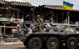 A Ukrainian soldier patrols in an armored vehicle on a street in Bucha, northwest of Kyiv, on April 2, 2022. (Ronaldo Schemidt/AFP)