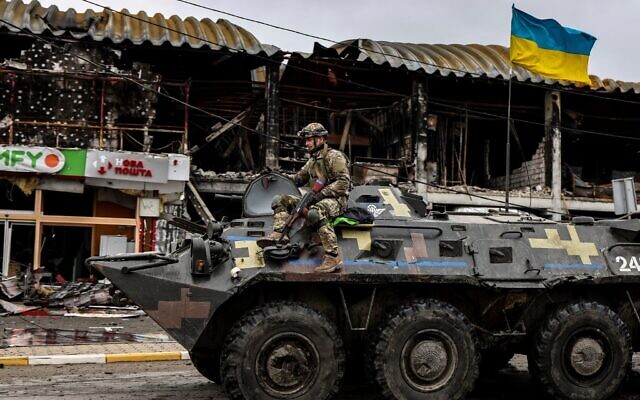 A Ukrainian soldier patrols in an armored vehicle on a street in Bucha, northwest of Kyiv, on April 2, 2022. (Ronaldo Schemidt/AFP) A Ukrainian soldier patrols in an armored vehicle on a street in Bucha, northwest of Kyiv, on April 2, 2022. (Ronaldo Schemidt/AFP)