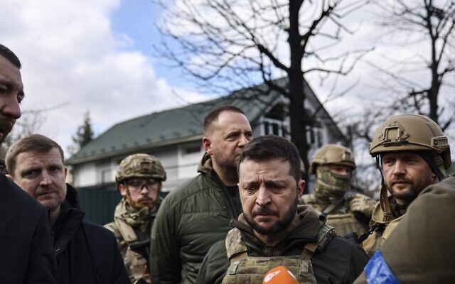 Ukrainian President Volodymyr Zelensky (C) speaks to the press in the town of Bucha, northwest of the Ukrainian capital Kyiv, on April 4, 2022. (Ronaldo Schemidt/AFP) Ukrainian President Volodymyr Zelensky (C) speaks to the press in the town of Bucha, northwest of the Ukrainian capital Kyiv, on April 4, 2022. (Ronaldo Schemidt/AFP)