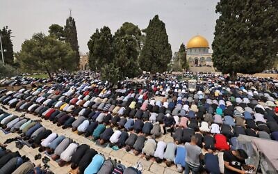 Palestinians attend afternoon prayers on the Temple Mount, which houses the Al-Aqsa Mosque, in Jerusalem's Old City, on April 8, 2022, during the first Friday of the Muslim holy month of Ramadan. (Ahmad Gharabli/AFP)