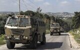 Israeli military vehicles drive in the Jenin refugee camp in the northern West Bank, on April 9, 2022. (Jaafar Ashtiyeh/AFP)