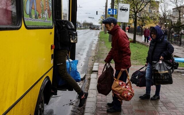 Illustrative: People board a bus leaving Severodonetsk in eastern Ukraine's Donbas region on April 13, 2022. (Ronaldo Schemidt/AFP) Illustrative: People board a bus leaving Severodonetsk in eastern Ukraine's Donbas region on April 13, 2022. (Ronaldo Schemidt/AFP)