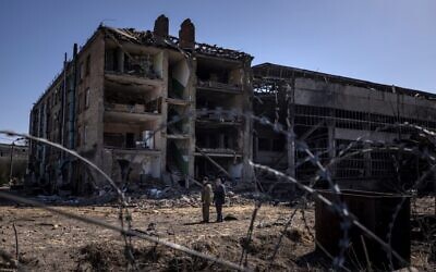 People stand beside damaged buildings at the Vizar company military-industrial complex, after the site was hit by overnight Russian strikes, in the town of Vyshneve, southwestern suburbs of Kyiv, on April 15, 2022. (Fadel Senna/AFP) People stand beside damaged buildings at the Vizar company military-industrial complex, after the site was hit by overnight Russian strikes, in the town of Vyshneve, southwestern suburbs of Kyiv, on April 15, 2022. (Fadel Senna/AFP)