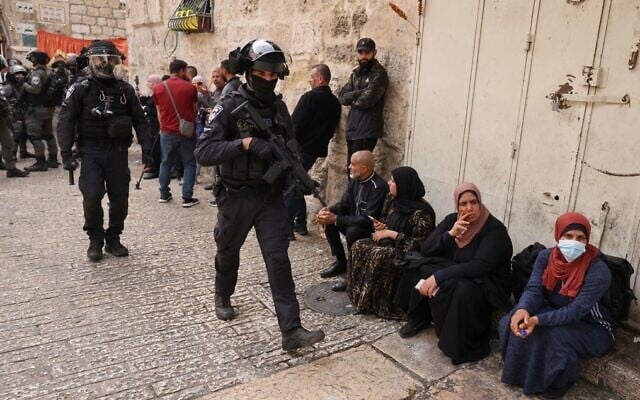 Israeli border police patrol near of the Lion's Gate in Jerusalem's Old City, as Palestinians wait to enter the Temple Mount compound, on April 17, 2022. (Ahmad Gharabli/AFP)
