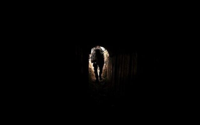 A member of Palestinian Islamic Jihad terror group enters a tunnel in the Gaza Strip, on April 17, 2022, during a media tour amid escalating violence with Israel. (Mahmud Hams/AFP)