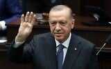 Turkish President Recep Tayyip Erdogan waves as he arrives to give a speech during a party parliamentary group meeting at the Grand National Assembly of Turkey (GNAT) in Ankara, Turkey, on April 20, 2022. (Adem Altan/AFP)
