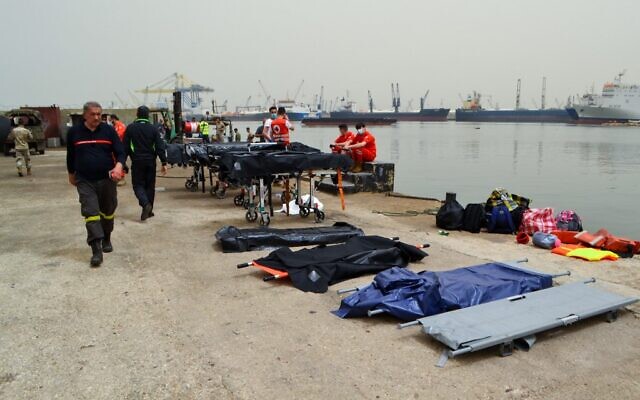 Medics wait on the pier as soldiers search for survivors off the coast of the northern Lebanese city of Tripoli on April 24, 2022, after an overloaded migrant boat capsized off north Lebanon during a chase by naval forces. (Fathi AL-MASRI / AFP) Medics wait on the pier as soldiers search for survivors off the coast of the northern Lebanese city of Tripoli on April 24, 2022, after an overloaded migrant boat capsized off north Lebanon during a chase by naval forces. (Fathi AL-MASRI / AFP)