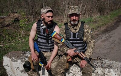 Ukrainian servicemen Vasyl, 51, and his son Denys, 22, (L) pose at a checkpoint near Barvinkove, eastern Ukraine, on April 25, 2022, amid the Russian invasion of Ukraine. (Yasuyoshi Chiba/AFP) Ukrainian servicemen Vasyl, 51, and his son Denys, 22, (L) pose at a checkpoint near Barvinkove, eastern Ukraine, on April 25, 2022, amid the Russian invasion of Ukraine. (Yasuyoshi Chiba/AFP)