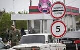 A Transnistrian serviceman watches cars entering the self-proclaimed "Moldovan Republic of Transnistria" at the Varnita crossing with Moldova on April 28, 2022.  (Daniel Mihailescu/AFP)