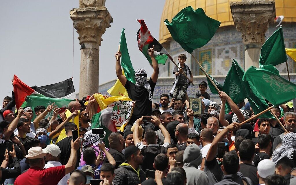 Palestinians wave Palestinian and Islamic flags as they rally at the Al-Aqsa Mosque on the Temple Mount in Jerusalem, following the last Friday prayers of the Muslim holy month of Ramadan, on April 29, 2022. (Ahmad Gharabli/AFP) Palestinians wave Palestinian and Islamic flags as they rally at the Al-Aqsa Mosque on the Temple Mount in Jerusalem, following the last Friday prayers of the Muslim holy month of Ramadan, on April 29, 2022. (Ahmad Gharabli/AFP)