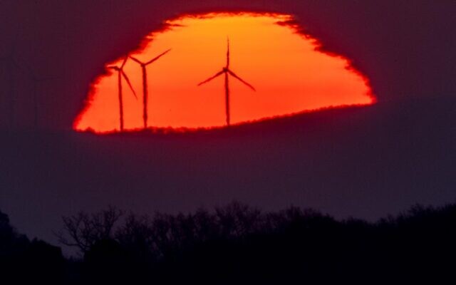 Wind turbines stand in front of the rising sun in Frankfurt, Germany, March 11, 2022. (AP/Michael Probst, File) Wind turbines stand in front of the rising sun in Frankfurt, Germany, March 11, 2022. (AP/Michael Probst, File)