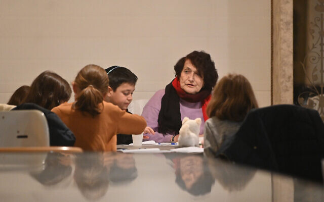 A woman, known to her students as Mrs. Rozaliya, teaches them at the refugee camp in Irshava, Ukraine, April 5, 2022. (Cnaan Liphshiz/ JTA)