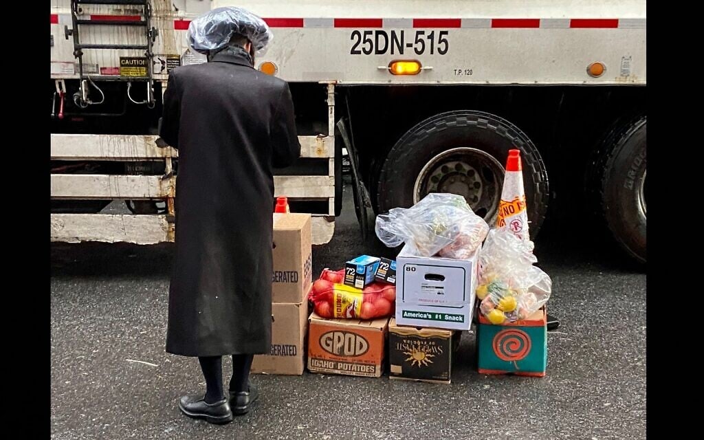 A Satmar Orthodox man volunteers to deliver free food provided by Met Council at a distribution center at the Brooklyn Navy Yard run by the United Jewish Organizations of Williamsburg, on April 10, 2022. (Jacob Henry/JTA) A Satmar Orthodox man volunteers to deliver free food provided by Met Council at a distribution center at the Brooklyn Navy Yard run by the United Jewish Organizations of Williamsburg, on April 10, 2022. (Jacob Henry/JTA)