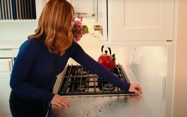 In a promotional video for Kosher Dekal, a woman takes off the product from a kitchen counter. (YouTube/ via JTA)