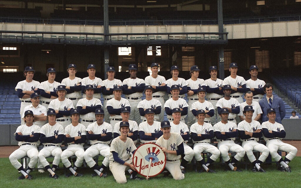 The New York Yankees pose for a group portrait in 1972. From left to right, front row: Celerino Sanchez, Bobby Murcer, Fred Beene, Elston Howard, Jim Hegan, Ralph Houk, Jim Turner, Dick Howser, Horace Clarke, Roy White, Johnny Callison. Second row: Joe Soares, Hal Lanier, Ron Swoboda, Ron Blomberg, Rob Gardner, Bernie Allen, Thurman Munson, Jerry Kenney, Pete Sheehy, Rob Franklin. Third row:  Mike Kekich, Fritz Peterson, Steve Kline, Mel Stottlemyre, Sparky Lyle, Charlie Spikes, Lindy McDaniel, Ron Klimkowski, John Ellis, Wade Blasingame, Gene Michael, Felipe Alou. Seated on ground: batboys Kevin Melchior and Gerry Murphy. (AP Photo)
