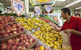 In this May 23, 2011 photo, customer Gabriel Sanchez shops for fresh fruit at a Superior Grocers store in Los Angeles.  (AP Photo/Damian Dovarganes)
