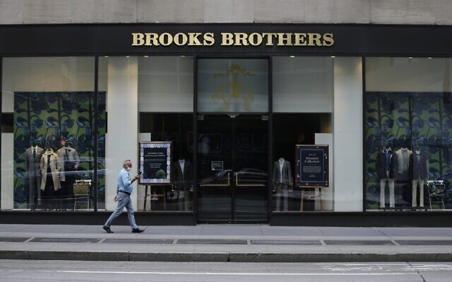 Pedestrians wearing protective masks walk past a Brooks Brothers store in New York, on July 8, 2020. (Frank Franklin II/AP) Pedestrians wearing protective masks walk past a Brooks Brothers store in New York, on July 8, 2020. (Frank Franklin II/AP)
