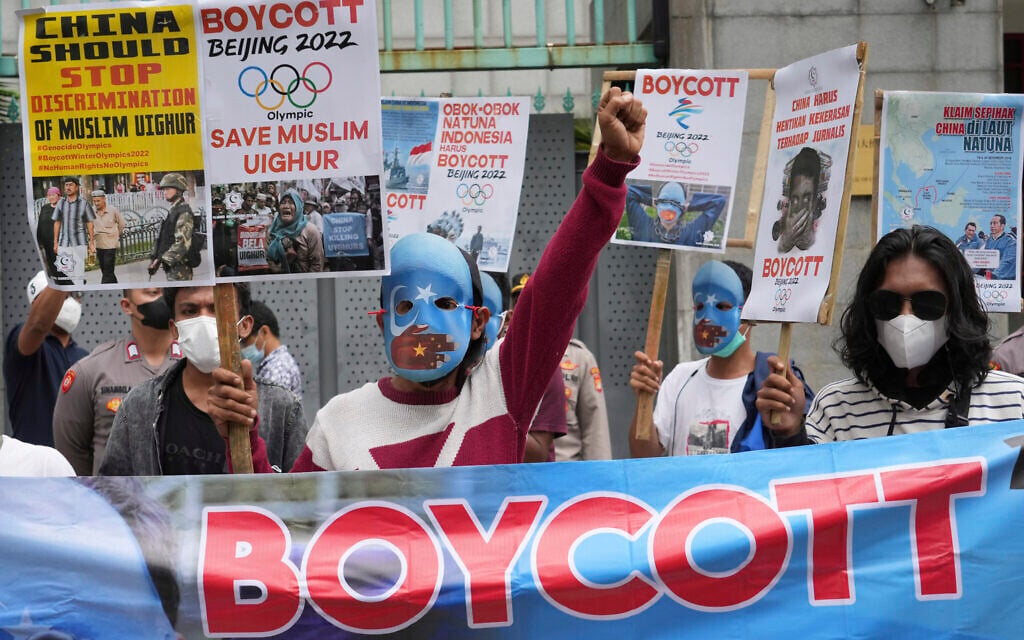 Illustrative: Student activists, some wearing masks with the colors of the pro-independence East Turkistan flag, shout slogans during a rally to protest the Beijing 2022 Winter Olympic Games, outside the Chinese Embassy in Jakarta, Indonesia, Friday, January 14, 2022. (AP Photo/Tatan Syuflana)