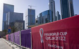 A view of the fence around the Doha Exhibition and Convention Center where soccer's World Cup draw was held on April 1, 2022. (AP Photo/Darko Bandic)