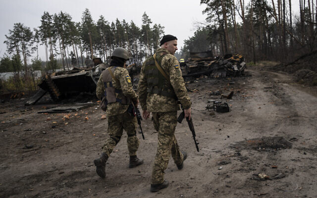 Ukrainian soldiers walk next to destroyed Russian tanks in the outskirts of Kyiv, Ukraine, March 31, 2022. (AP Photo/Rodrigo Abd) Ukrainian soldiers walk next to destroyed Russian tanks in the outskirts of Kyiv, Ukraine, March 31, 2022. (AP Photo/Rodrigo Abd)
