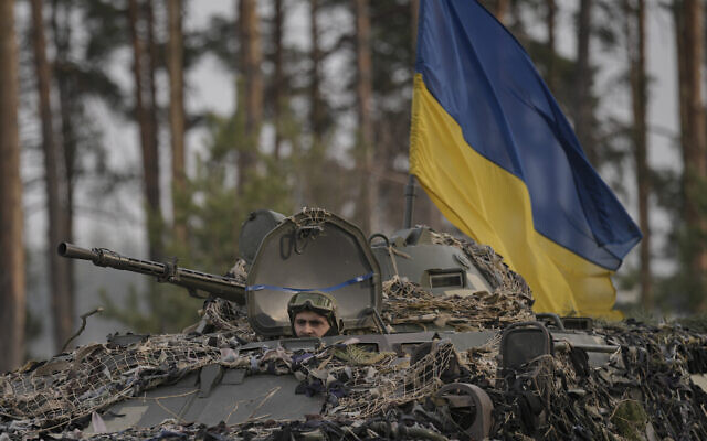 Ukrainian servicemen ride on an armored transporter driving through a Russian position overran by Ukrainian forces outside Kyiv, Ukraine, on March 31, 2022. (AP Photo/Vadim Ghirda) Ukrainian servicemen ride on an armored transporter driving through a Russian position overran by Ukrainian forces outside Kyiv, Ukraine, on March 31, 2022. (AP Photo/Vadim Ghirda)