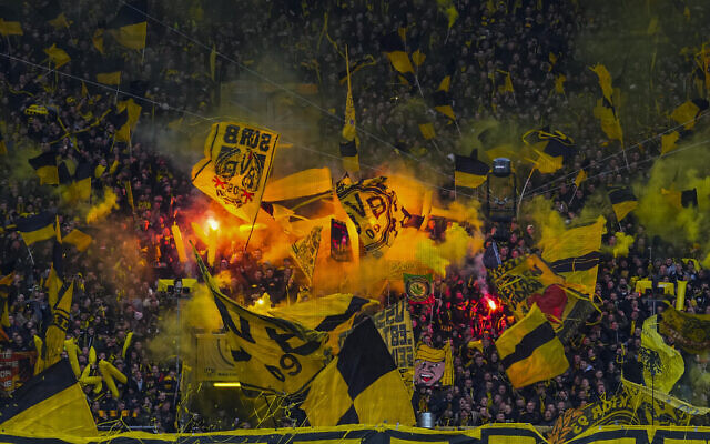 Illustrative: Dortmund fans set off flares at the start of the German Bundesliga soccer match between Borussia Dortmund and RB Leipzig in Dortmund, Germany, April 2, 2022. (AP Photo/Martin Meissner)