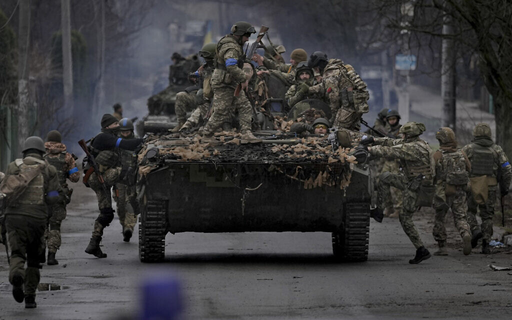 Ukrainian servicemen climb on a fighting vehicle outside Kyiv, Ukraine, Saturday, April 2, 2022. (AP Photo/Vadim Ghirda) Ukrainian servicemen climb on a fighting vehicle outside Kyiv, Ukraine, Saturday, April 2, 2022. (AP Photo/Vadim Ghirda)
