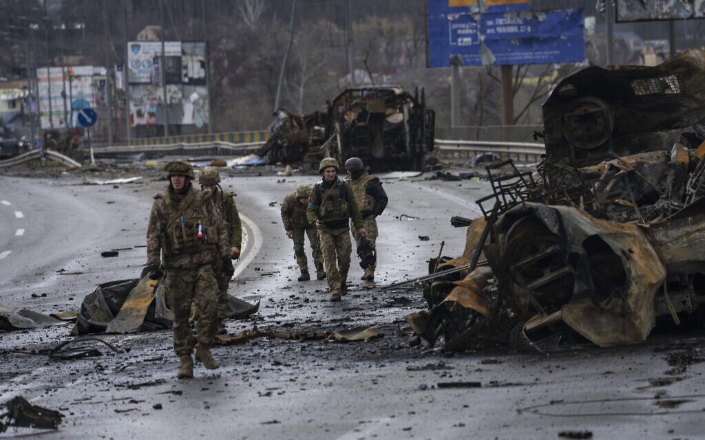 Ukrainian soldiers walk next to destroyed Russians armored vehicles in Bucha, Ukraine, Saturday, April 2, 2022. (AP Photo/Rodrigo Abd) Ukrainian soldiers walk next to destroyed Russians armored vehicles in Bucha, Ukraine, Saturday, April 2, 2022. (AP Photo/Rodrigo Abd)