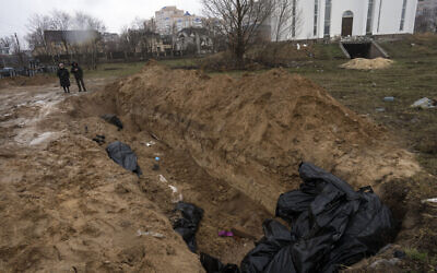 Neighbours gather next to a mass grave in Bucha, in the outskirts of Kyiv, Ukraine, April 3, 2022. (AP Photo/Rodrigo Abd) Neighbours gather next to a mass grave in Bucha, in the outskirts of Kyiv, Ukraine, April 3, 2022. (AP Photo/Rodrigo Abd)