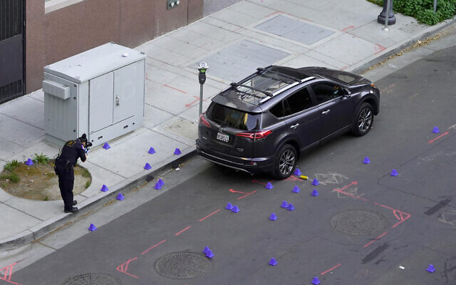 A crime scene investigator photograph evidence markers at the scene of a mass shooting In Sacramento, Calif. April 3, 2022. (AP Photo/Rich Pedroncelli) A crime scene investigator photograph evidence markers at the scene of a mass shooting In Sacramento, Calif. April 3, 2022. (AP Photo/Rich Pedroncelli)