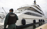 A Civil Guard stands by the yacht called Tango in Palma de Mallorca, Spain, April 4, 2022. (AP Photo/Francisco Ubilla)