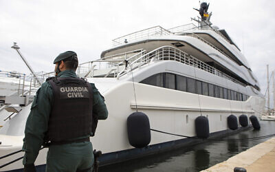 A Civil Guard stands by the yacht called Tango in Palma de Mallorca, Spain, April 4, 2022. (AP Photo/Francisco Ubilla)