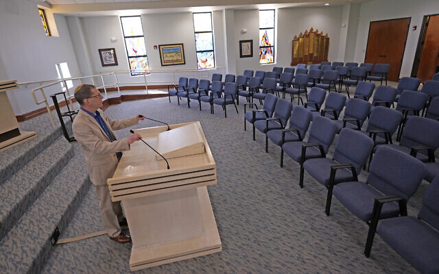 Rabbi Charlie Cytron-Walker adjusts the microphones while testing the sound system at Congregation Beth Israel in Colleyville, Texas, Thursday, April 7, 2022. Three months after an armed captor took hostages at the Texas synagogue during a 10-hour standoff that ended with the escape of the hostages and fatal shooting of the gunman by the FBI, the house of worship is reopening. (AP Photo/LM Otero) Rabbi Charlie Cytron-Walker adjusts the microphones while testing the sound system at Congregation Beth Israel in Colleyville, Texas, Thursday, April 7, 2022. Three months after an armed captor took hostages at the Texas synagogue during a 10-hour standoff that ended with the escape of the hostages and fatal shooting of the gunman by the FBI, the house of worship is reopening. (AP Photo/LM Otero)
