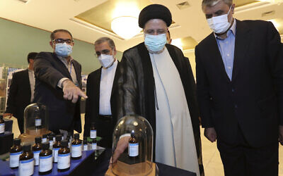 Iranian President Ebrahim Raisi, second right, receives an explanation while visiting an exhibition of Iran's nuclear achievements in Tehran, Iran, April 9, 2022. (Photo released by Iranian Presidency Office via AP)