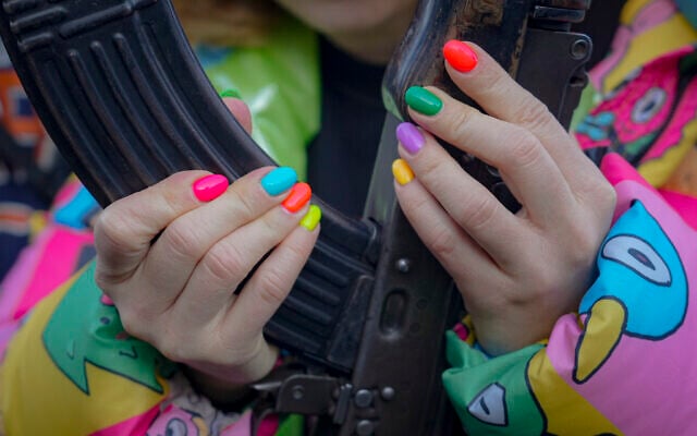 A young woman handles a weapon during a basic combat training for civilians, organized by the Special Forces Unit Azov, of Ukraine's National Guard, in Mariupol, Donetsk region, eastern Ukraine, on Sunday, February 13, 2022. (AP Photo/Vadim Ghirda) A young woman handles a weapon during a basic combat training for civilians, organized by the Special Forces Unit Azov, of Ukraine's National Guard, in Mariupol, Donetsk region, eastern Ukraine, on Sunday, February 13, 2022. (AP Photo/Vadim Ghirda)