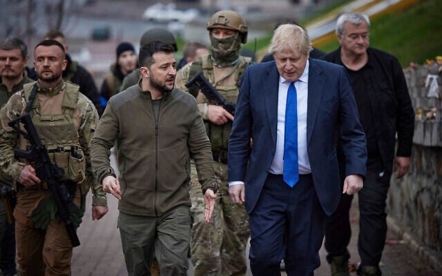 Ukrainian President Volodymyr Zelensky, center left, and Britain's Prime Minister Boris Johnson, center right, walk past a memorial for Heavenly Hundred, near Independence Square in Kyiv, Ukraine, on April 9, 2022. (Ukrainian Presidential Press Office via AP) Ukrainian President Volodymyr Zelensky, center left, and Britain's Prime Minister Boris Johnson, center right, walk past a memorial for Heavenly Hundred, near Independence Square in Kyiv, Ukraine, on April 9, 2022. (Ukrainian Presidential Press Office via AP)