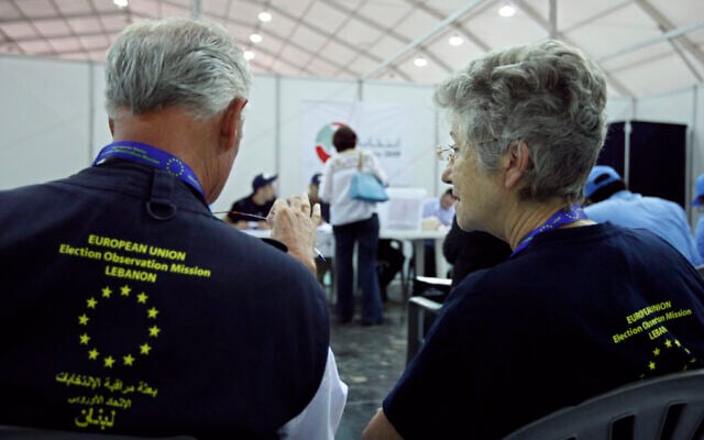 Two European Union election observers watch as an election worker casts her ballot in early voting in Beirut, Lebanon, June 4, 2009. (AP Photo/Bilal Hussein, File ) Two European Union election observers watch as an election worker casts her ballot in early voting in Beirut, Lebanon, June 4, 2009. (AP Photo/Bilal Hussein, File )