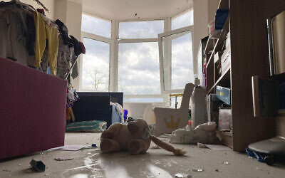 A stuffed toy lies abandoned amid broken glass in a war-damaged apartment in Irpin, Ukraine, on Monday, April 11, 2022. (AP Photo/Cara Anna)