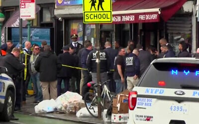 This still image provided by WABC shows law enforcement gathering at the scene of a shooting in the Brooklyn borough of New York, on April 12, 2022. (WABC via AP)
