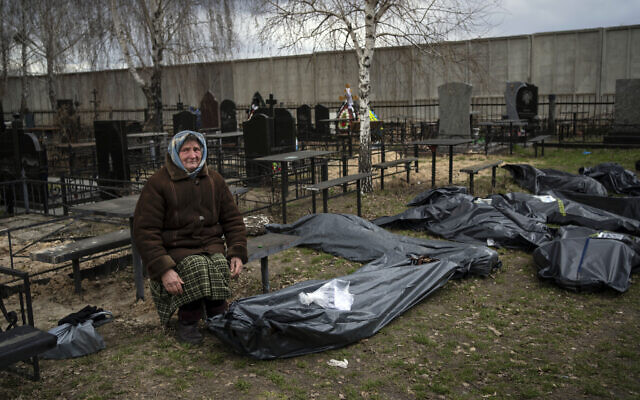 Nadiya Trubchaninova, 70, sits next to a plastic bag that contains the body of her son Vadym Trubchaninov, 48, who was killed by Russian soldiers in Bucha on March 30, in the outskirts of Kyiv, Ukraine, Tuesday, April 12, 2022. (AP/Rodrigo Abd) Nadiya Trubchaninova, 70, sits next to a plastic bag that contains the body of her son Vadym Trubchaninov, 48, who was killed by Russian soldiers in Bucha on March 30, in the outskirts of Kyiv, Ukraine, Tuesday, April 12, 2022. (AP/Rodrigo Abd)
