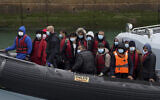 A group of people thought to be migrants are brought in to Dover, Kent, in the United  Kingdom, on board a Border Force vessel following a small boat incident in the Channel, April 13, 2022. (Gareth Fuller/PA via AP)