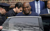 Law enforcement officials lead subway shooting suspect Frank R. James, 62, center right, away from a police station and into a vehicle, in New York, on April 13, 2022. (AP Photo/John Minchillo)