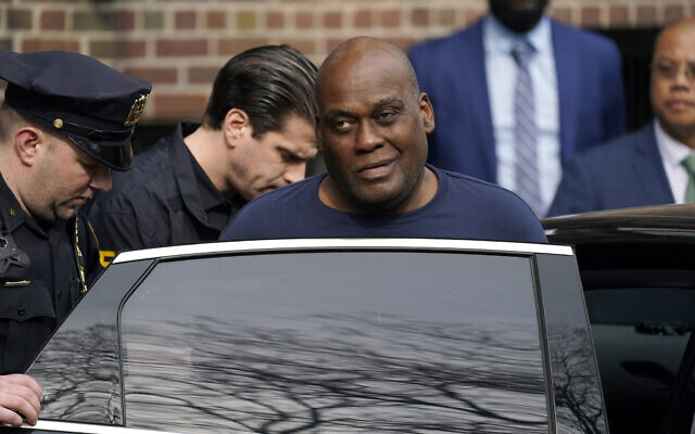Law enforcement officials lead subway shooting suspect Frank R. James, 62, center right, away from a police station and into a vehicle, in New York, on April 13, 2022. (AP Photo/John Minchillo)