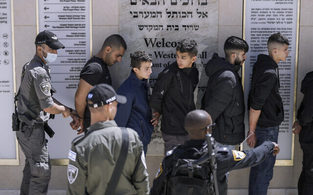 Detained Palestinian demonstrators are handcuffed following clashes at the Al-Aqsa Mosque compound between Palestinians and Israeli police, at the Temple Mount in Jerusalem's Old City, on April 15, 2022. (AP Photo/Ariel Schalit) Detained Palestinian demonstrators are handcuffed following clashes at the Al-Aqsa Mosque compound between Palestinians and Israeli police, at the Temple Mount in Jerusalem's Old City, on April 15, 2022. (AP Photo/Ariel Schalit)