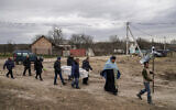 Liudmila Sumanchuk, third left, walks during the funeral ceremony for her granddaughter Veronika Kuts in Lgiv village, Chernihiv region, Ukraine, April 8, 2022. (AP Photo/Evgeniy Maloletka)