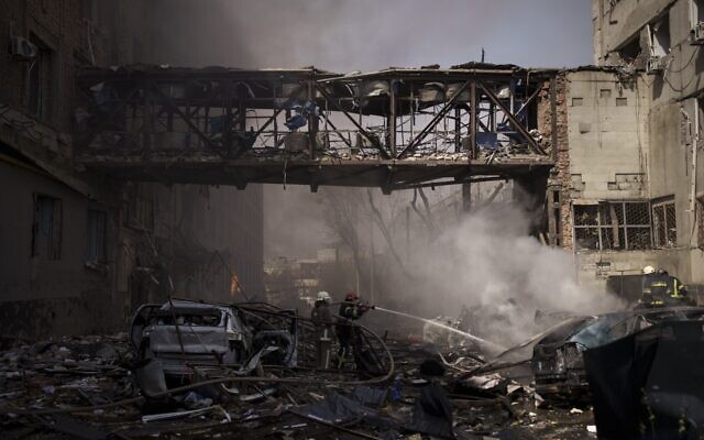 Firefighters work to extinguish multiple fires after a Russian attack in Kharkiv, Ukraine, on April 16, 2022. (AP Photo/Felipe Dana)