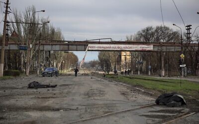 Bodies of civilians lie on the ground as local residents walk past a destroyed part of the Illich Iron & Steel Works Metallurgical Plant, the second largest metallurgical enterprise in Ukraine, in an area controlled by Russian-backed separatist forces in Mariupol, Ukraine, on April 16, 2022. (AP Photo/Alexei Alexandrov) Bodies of civilians lie on the ground as local residents walk past a destroyed part of the Illich Iron & Steel Works Metallurgical Plant, the second largest metallurgical enterprise in Ukraine, in an area controlled by Russian-backed separatist forces in Mariupol, Ukraine, on April 16, 2022. (AP Photo/Alexei Alexandrov)